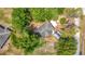 A home, from above, surrounded by mature trees and a detached garage at 6203 Sumter Dr, Brooksville, FL 34602