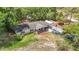 Aerial view of a cozy home featuring a front porch, boat and ample parking at 6203 Sumter Dr, Brooksville, FL 34602