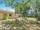 View of the backyard, including a playground set and the exterior of the home at 6203 Sumter Dr, Brooksville, FL 34602