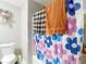 Bathroom featuring a shower with a flower patterned shower curtain and matching towels hanging nearby at 6203 Sumter Dr, Brooksville, FL 34602
