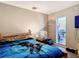 A bedroom with a wood frame bed, a ceiling fan and a dark gray painted wall at 6203 Sumter Dr, Brooksville, FL 34602