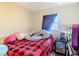 This bedroom offers cozy comfort with hardwood floors and a colorful bedspread at 6203 Sumter Dr, Brooksville, FL 34602