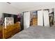 This bedroom features a dresser, closet storage, and a fan for comfort at 6203 Sumter Dr, Brooksville, FL 34602