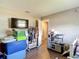 This bedroom features wood floors, a flat-screen television and closet storage at 6203 Sumter Dr, Brooksville, FL 34602