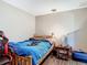 The bedroom is minimally furnished with a rustic wood frame bed and a side table at 6203 Sumter Dr, Brooksville, FL 34602