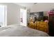 Bedroom features a wooden dresser, a fan, and a flat screen TV mounted to the wall at 6203 Sumter Dr, Brooksville, FL 34602