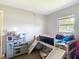 This bedroom has a slide bed, a play kitchen, and a window for natural light at 6203 Sumter Dr, Brooksville, FL 34602