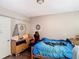 The bedroom features a comfortable bed, a dresser and a gaming chair at 6203 Sumter Dr, Brooksville, FL 34602