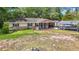 Charming one-story home featuring a covered front porch and a well-maintained lawn with mature trees at 6203 Sumter Dr, Brooksville, FL 34602