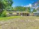 Charming one-story home featuring a covered front porch and a well-maintained lawn with mature trees at 6203 Sumter Dr, Brooksville, FL 34602