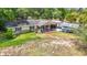 Charming one-story home featuring a covered front porch and a well-maintained lawn with mature trees at 6203 Sumter Dr, Brooksville, FL 34602