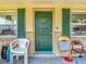 Inviting home entrance with decorative front door, sidelight windows with shutters, and stone exterior accents at 6203 Sumter Dr, Brooksville, FL 34602