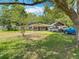 Charming one-story home surrounded by mature trees and a well-manicured lawn and boat parking at 6203 Sumter Dr, Brooksville, FL 34602