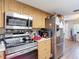 Kitchen with stainless steel appliances, light wood cabinets, laminate flooring, and a neutral color scheme at 6203 Sumter Dr, Brooksville, FL 34602