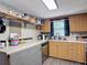 Functional kitchen space with updated laminate floors, wood cabinetry, and ample counter space at 6203 Sumter Dr, Brooksville, FL 34602