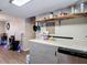 Kitchen area featuring laminate counters, open shelving, and a gray paneled texture along the base cabinets at 6203 Sumter Dr, Brooksville, FL 34602
