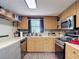 A functional kitchen space features laminate floors, wood cabinetry, and stainless steel microwave and oven at 6203 Sumter Dr, Brooksville, FL 34602