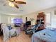 Open living area with wood-look floors, gaming chairs, modern television, and neutral paint at 6203 Sumter Dr, Brooksville, FL 34602