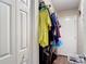 View of a walk-in closet with hanging clothes and a laundry basket in the corner at 6203 Sumter Dr, Brooksville, FL 34602