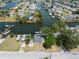 Aerial view of waterfront property with boat dock, boat and lush greenery and a canal front view at 6521 Boatyard Dr, Hudson, FL 34667