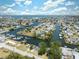 Waterfront community featuring canal access with docks and boat parking spaces, lush trees, and well-maintained homes at 6521 Boatyard Dr, Hudson, FL 34667