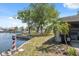 Waterfront backyard featuring a mini-lighthouse and mature trees offering shade and character at 6521 Boatyard Dr, Hudson, FL 34667