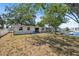 Rear view of property showcasing the expansive backyard with waterfront views and dock at 6521 Boatyard Dr, Hudson, FL 34667