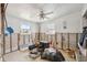 A bedroom awaits renovation, revealing wall framing and concrete blocks under two bright windows with ceiling fan overhead at 6521 Boatyard Dr, Hudson, FL 34667
