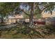 Single story home featuring a front yard with mature shade trees, tidy landscaping, and ample parking at 6521 Boatyard Dr, Hudson, FL 34667