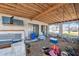 An outdoor porch space needs renovation, showcasing a wooden ceiling, screened windows and potential for custom design at 6521 Boatyard Dr, Hudson, FL 34667