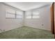 Bedroom featuring carpet, two windows and a closet at 6611 Ridge Crest Dr, Port Richey, FL 34668