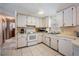 Functional kitchen design with white cabinets, tile backsplash, and practical appliances at 6611 Ridge Crest Dr, Port Richey, FL 34668