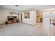 Spacious living room area with tile flooring adjacent to open kitchen at 6611 Ridge Crest Dr, Port Richey, FL 34668