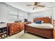 Bedroom featuring a large bed, wooden dresser and dual windows at 6611 Ridge Crest Dr, Port Richey, FL 34668