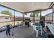 Enclosed pool area featuring a grill, table, and chairs, creating an inviting space for relaxation and outdoor activities at 6611 Ridge Crest Dr, Port Richey, FL 34668