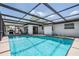 Enclosed pool area with ample sunlight, offering a relaxing outdoor space at 6611 Ridge Crest Dr, Port Richey, FL 34668
