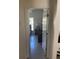 Cozy bedroom view through doorway, features neutral walls, window with blind, and a bedside table at 7144 Gulf Breeze Cir, Hudson, FL 34667