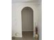 Welcoming entryway featuring an arched doorway, neutral paint, and decorative vase enhancing the space at 7144 Gulf Breeze Cir, Hudson, FL 34667