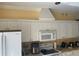 Updated kitchen with white cabinetry, stainless steel microwave, and range hood for modern cooking at 7144 Gulf Breeze Cir, Hudson, FL 34667
