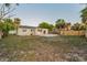 Spacious backyard with a patio, lush greenery, new fence, and a swing set for outdoor fun at 7235 Astor Dr, New Port Richey, FL 34652