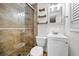 Bathroom featuring a glass door shower with tile surround, toilet, and vanity with drawers at 7235 Astor Dr, New Port Richey, FL 34652
