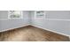 Bedroom with light blue walls and wood flooring at 7235 Astor Dr, New Port Richey, FL 34652