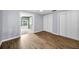 Bedroom with light blue walls, wood flooring and closet with view to the outside at 7235 Astor Dr, New Port Richey, FL 34652