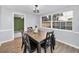The dining area features a modern table with chairs, and a large window with backyard views at 7235 Astor Dr, New Port Richey, FL 34652
