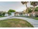 Attractive single-Gathering home boasting a large front yard with mature trees and a driveway at 7235 Astor Dr, New Port Richey, FL 34652