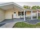 Charming home with a covered front porch, black shutters, and well-kept landscaping at 7235 Astor Dr, New Port Richey, FL 34652