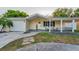 Charming single-story home with a well-manicured lawn and a welcoming front porch at 7235 Astor Dr, New Port Richey, FL 34652