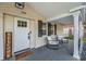 Inviting front porch with brick accents, seating area, and stylish decorative accents at 7235 Astor Dr, New Port Richey, FL 34652