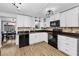 Updated kitchen with white cabinetry, black appliances, and modern countertops at 7235 Astor Dr, New Port Richey, FL 34652