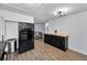 View of the kitchen, including black fridge, bar, and stainless trash receptacle at 7235 Astor Dr, New Port Richey, FL 34652